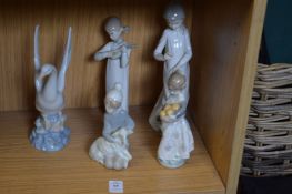 A group of Lladro and Nao figures.