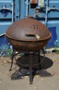 A large wrought iron charcoal barbecue.