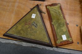 A nautical themed triangular shaped brass cribbage board together with another cribbage board.