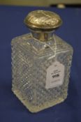 A Victorian cut glass and silver topped small decanter and stopper, London 1883.