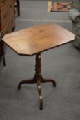 A mahogany tripod table.