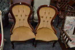 A pair of Victorian style button upholstered nursing chairs.