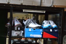 Two pairs of golfing shoes size 11 and 9½ together with a pair of trainers size 10.