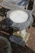 A composite garden bird bath.