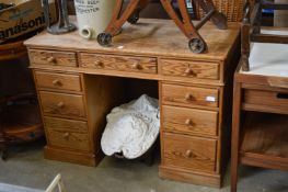 A pine pedestal desk.