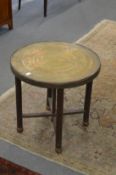 An Eastern engraved brass occasional table.