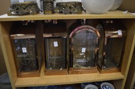 A set of four metal lanterns.