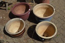 Four large glazed plant pots.