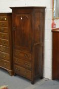 An oak cupboard with a panel door above three drawers.