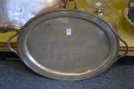 A large plated twin handled oval shaped tray.