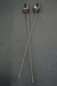 A pair of fencing foils.