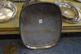 A silver plated tray with bun feet.