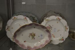 A porcelain oval shaped dish decorated in the centre with a classical urn, gilt anchor mark to the