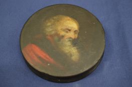 A small lacquer papier mache circular snuff box, the cover decorated with a elderly bearded