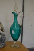 A turquoise glass claret jug.