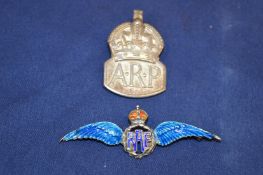 A silver ARP badge and an enamel and silver RAF badge.