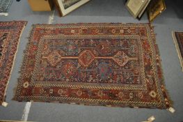 A Persian rug with geometric decoration, 207cm x 145cm.