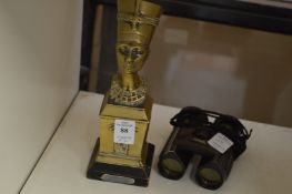 A cast bronze model of Nefertiti and a pair of binoculars.