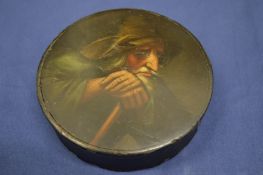 A lacquer papier mache circular snuff box, the cover decorated with a portrait of a elderly