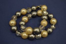 A Kenneth Lane bead work necklace.