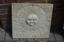 A sun burst wall plaque.