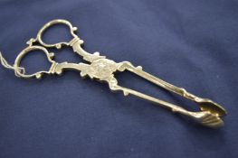 A pair of silver sugar nips.