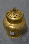 An Islamic chased and engraved gilded brass incense bowl and cover.