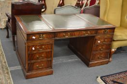 A large reproduction mahogany pedestal desk.