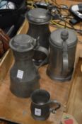 Pewter flagons and a small tankard.
