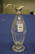 A silver mounted cut glass oil or vinegar bottle.