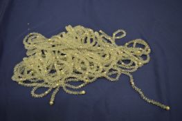 A very long crystal necklace.