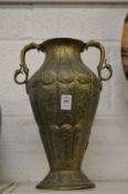 A good Islamic brass twin handled vase with engraved and chased decoration.