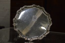 A silver waiter on three hoof feet.