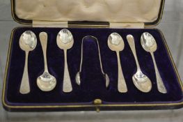 A cased set of six silver teaspoons and sugar nips, Sheffield 1915.