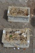 A pair of composite rectangular planters.