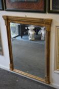A modern gilt framed over-mantel mirror.