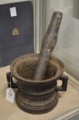 An early cast iron pestle and mortar.