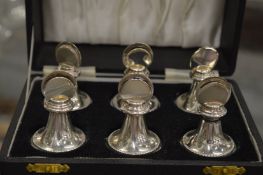 A cased set of six silver Capstan menu or place name holders, Birmingham 1960.