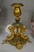 An ormolu and champleve enamel classical style candlestick.