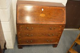 A Georgian style inlaid mahogany bureau.