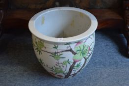 A Chinese jardiniere decorated with peach blossom.