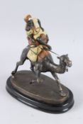 A BRONZE ARAB RIDING A CAMEL. 15ins high