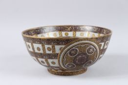 A CRACKLE GLAZE AND GILT DECORATED CIRCULAR POTTERY BOWL, painted with panels and bands of putti,