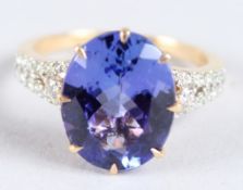 AN 18CT WHITE GOLD TANZANITE AND DIAMOND RING.