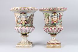 A LARGE PAIR OF CAPODIMONTE CAMPAGNE SHAPE PORCELAIN VASES, with female mask handles, the bodies