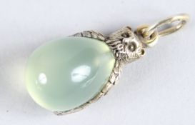 A SILVER JADE OWL EGG PENDANT.