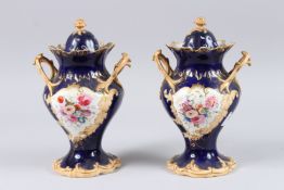 A PAIR OF 19TH CENTURY PORCELAIN MEMORIAL TWIN HANDLED VASES AND COVERS, blue ground, decorated with
