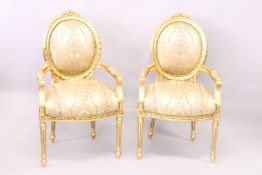 A PAIR OF FRENCH STYLE GILTWOOD FRAMED OPEN ARMCHAIRS.