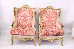 A PAIR OF FRENCH STYLE GILTWOOD FRAMED WING ARMCHAIRS.