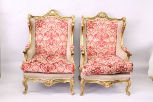 A PAIR OF FRENCH STYLE GILTWOOD FRAMED WING ARMCHAIRS.